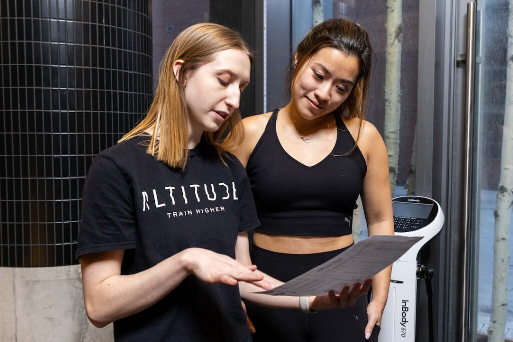 Two women look at some documents together